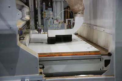 Precision machinery working on a panel in the Sierra factory